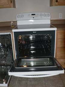 The lower elements of this GE range with a glass top and a self cleaning oven is hidden