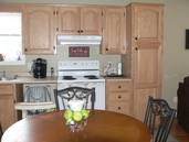 The kitchen cupboards from the sink to the right end.